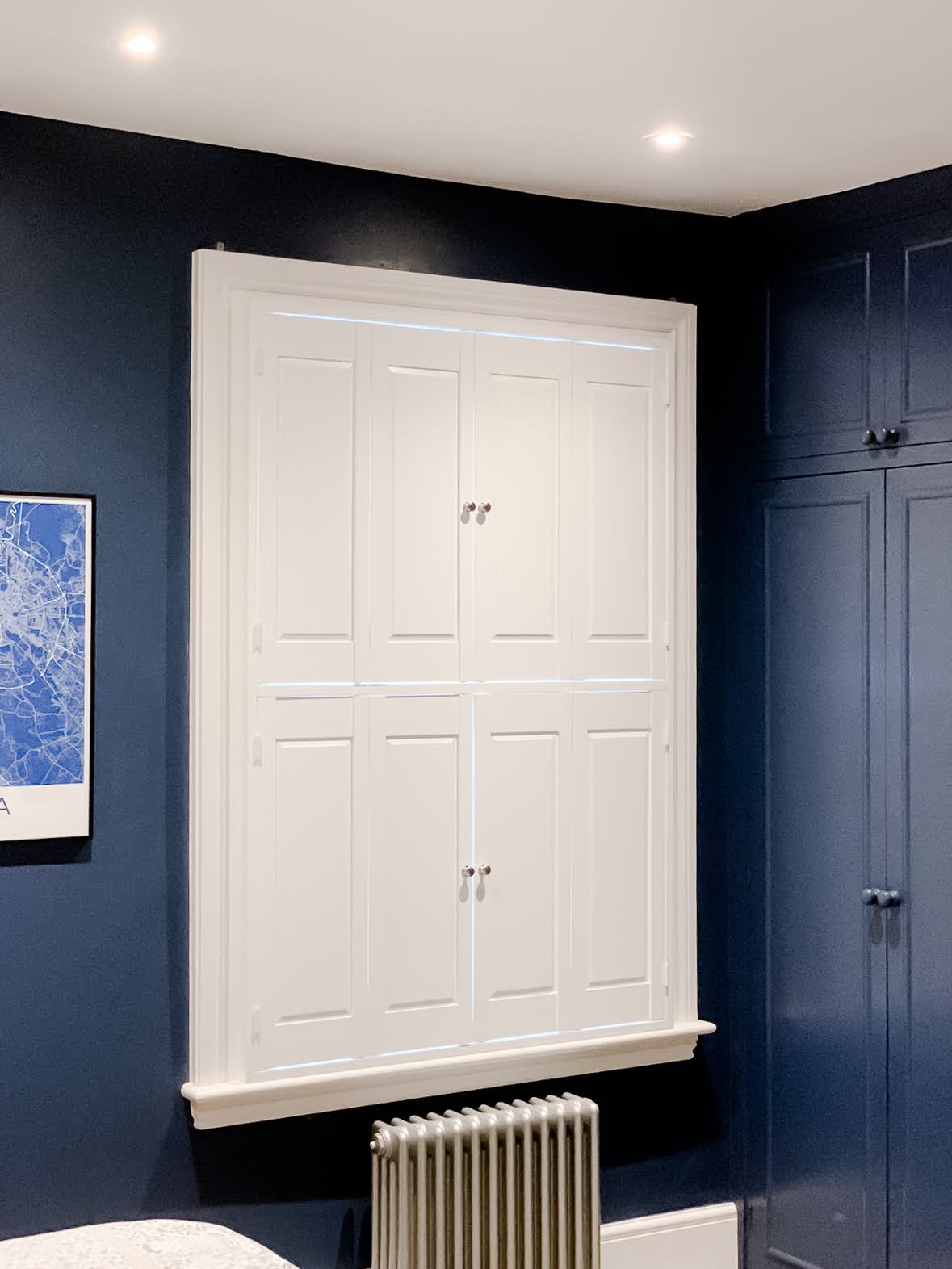 Solid panel shutters in a bedroom